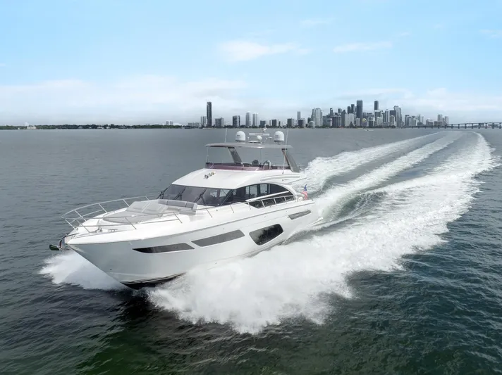 Definite Maybe Yacht Photos Pics 2019 Princess F70 yacht cruising on open water with city skyline in background.