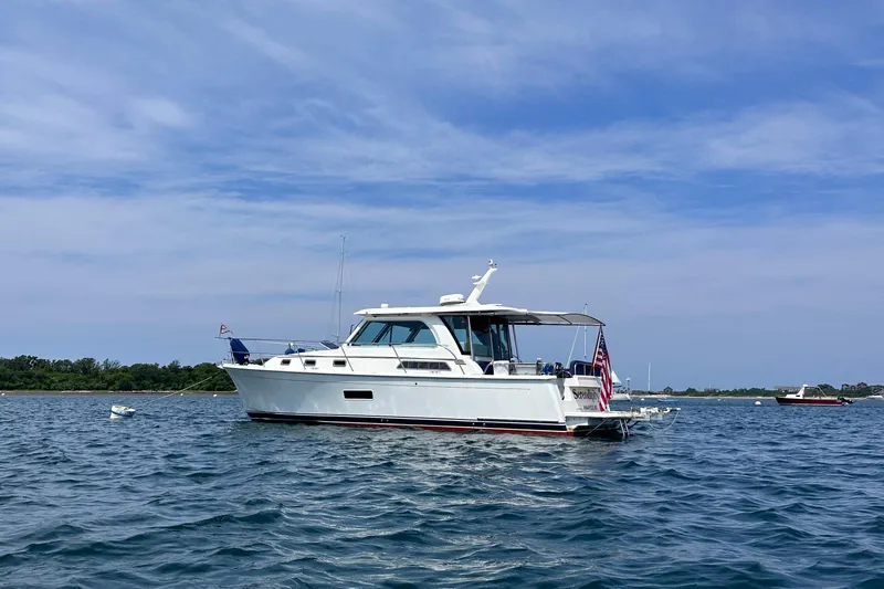 Serendipity Yacht Photos Pics 2019 Sabre 38 Salon Express yacht on calm water under blue sky.