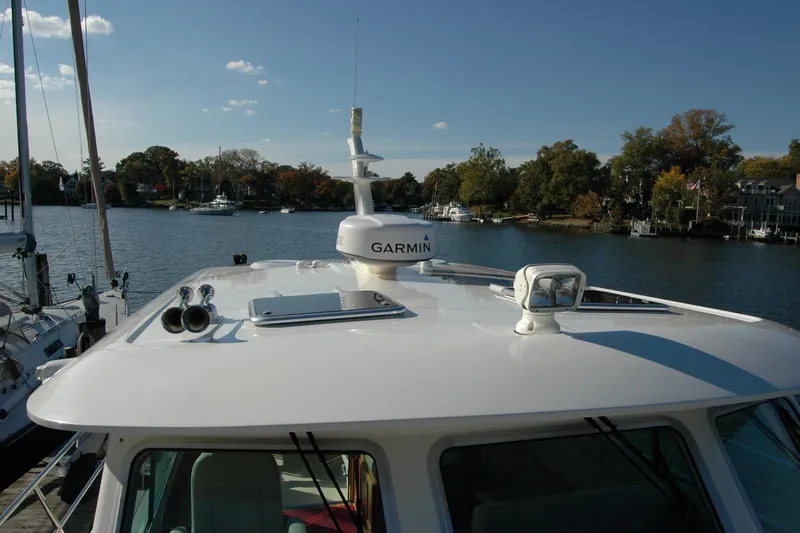 Serendipity Yacht Photos Pics 2019 Sabre 38 Salon Express yacht with Garmin equipment, docked by a scenic waterfront.