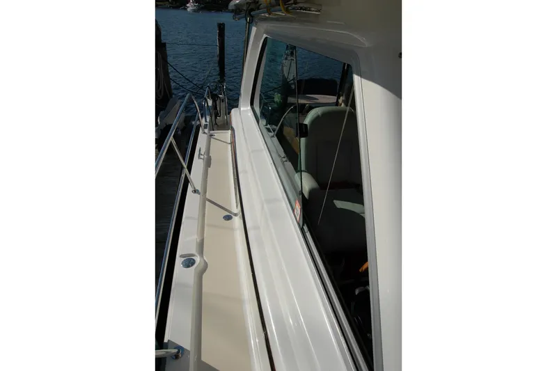 Serendipity Yacht Photos Pics 2019 Sabre 38 Salon Express yacht side deck with railing and window view.