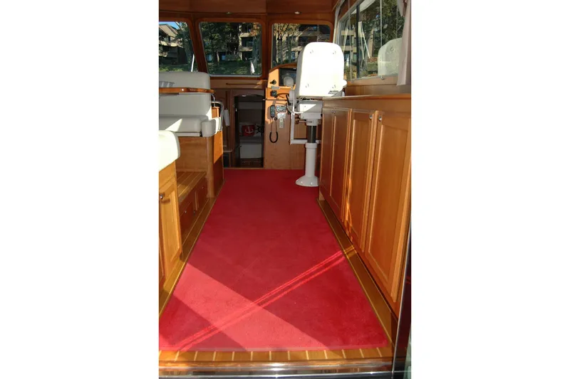 Serendipity Yacht Photos Pics Interior of 2019 Sabre 38 Salon Express with red carpet and wooden cabinetry.