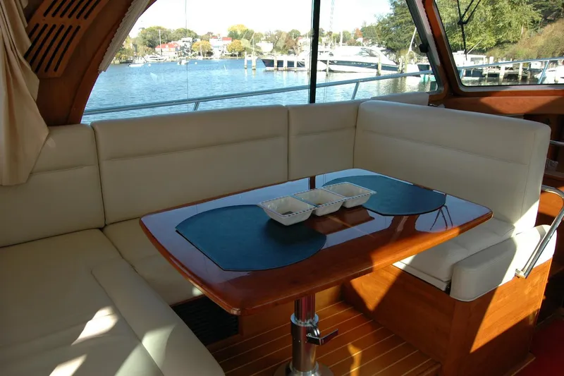 Serendipity Yacht Photos Pics Interior of 2019 Sabre 38 Salon Express yacht with elegant seating and table.