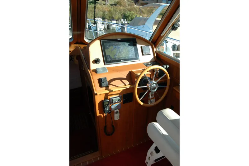 Serendipity Yacht Photos Pics 2019 Sabre 38 Salon Express helm with navigation equipment and wooden steering wheel.