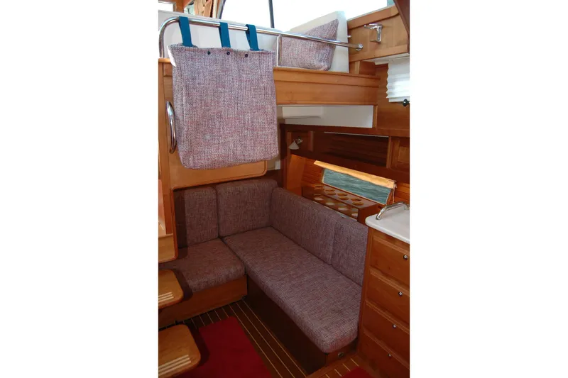Serendipity Yacht Photos Pics Interior of 2019 Sabre 38 Salon Express with cozy seating and wooden cabinetry.