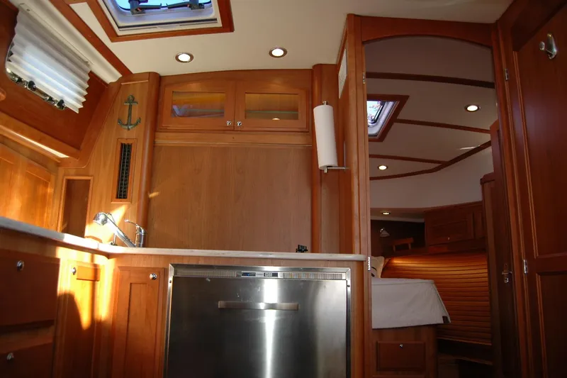 Serendipity Yacht Photos Pics 2019 Sabre 38 Salon Express interior with wood cabinetry and stainless steel appliances.