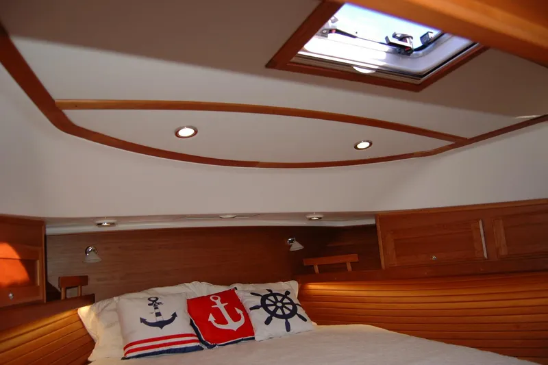 Serendipity Yacht Photos Pics 2019 Sabre 38 Salon Express cabin with nautical-themed pillows and wooden interior.