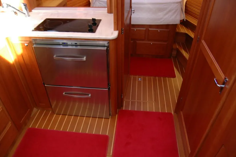 Serendipity Yacht Photos Pics Interior of 2019 Sabre 38 Salon Express yacht with modern kitchen and red rugs.