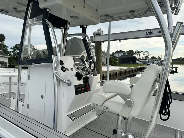  Yacht Photos Pics Modern boat cockpit with steering wheel, white seating, and control panel, Custom Shark Fin R321, 2023.