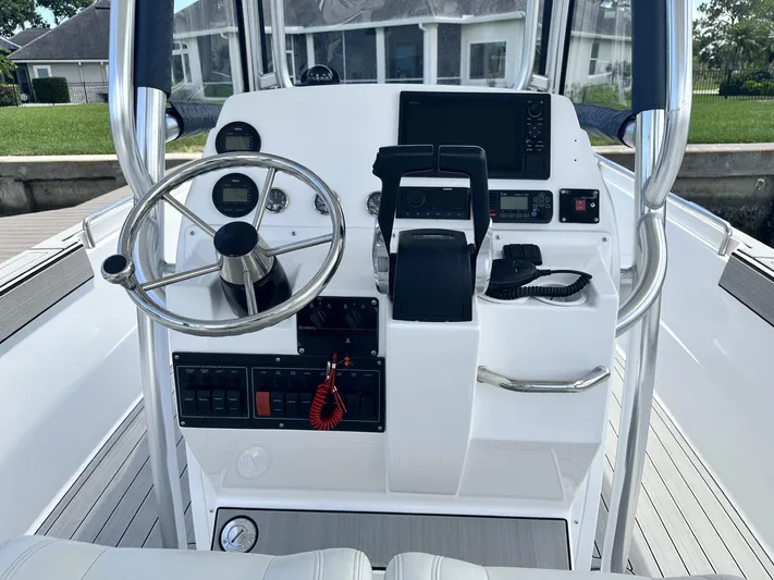  Yacht Photos Pics 2023 Custom Shark Fin R321 boat dashboard with steering wheel and navigation controls.