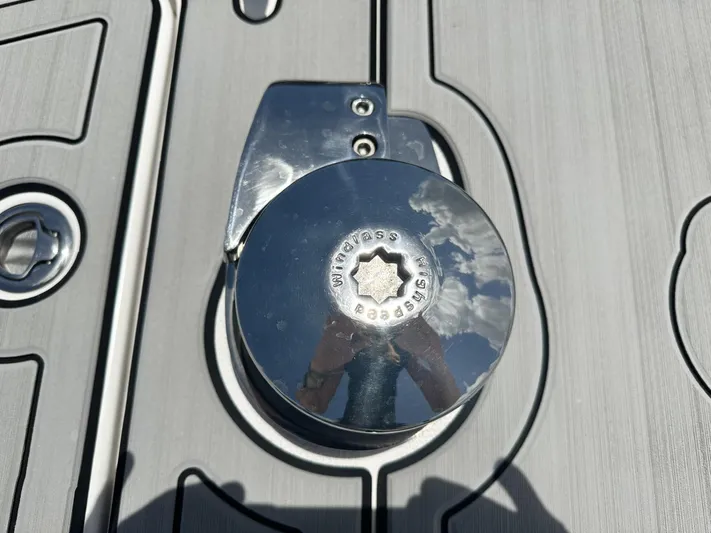  Yacht Photos Pics Shiny metal winch on a boat deck, reflecting clouds and sky, Custom Shark Fin R321, 2023.