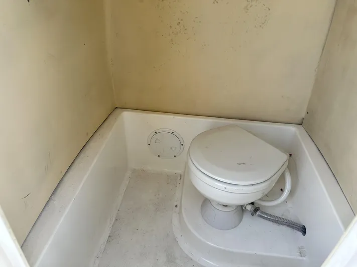  Yacht Photos Pics Compact marine toilet in a small, enclosed space, Custom Shark Fin R321, 2023 model.