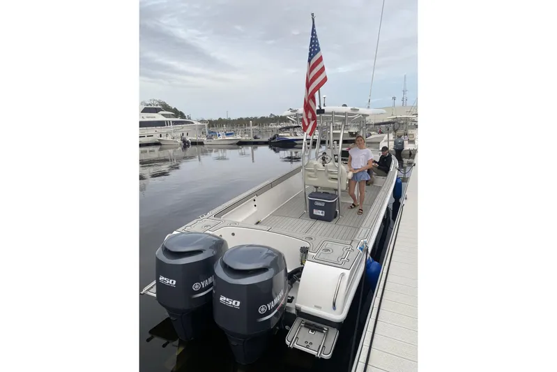  Yacht Photos Pics Custom Shark Fin R321 boat docked, featuring dual Yamaha engines and an American flag.