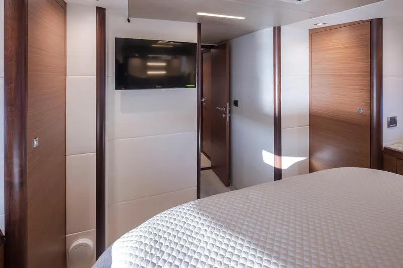 Crescent Moon Yacht Photos Pics Luxurious interior of 2017 Ocean Alexander 70e yacht with modern wood paneling and wall-mounted TV.