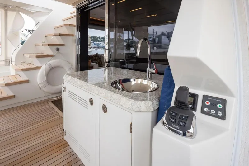 Crescent Moon Yacht Photos Pics 2017 Ocean Alexander 70E Motoryacht interior with sink, control panel, and wooden stairs.