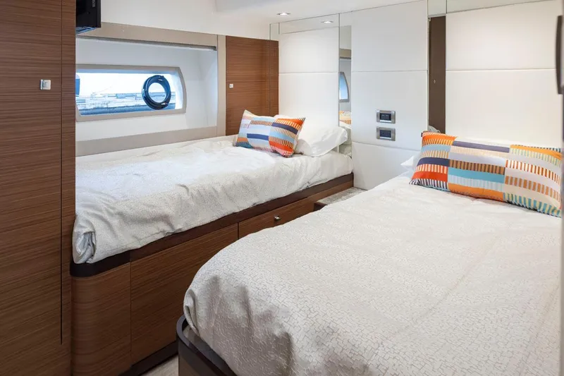 Crescent Moon Yacht Photos Pics Luxurious cabin interior of 2017 Ocean Alexander 70e yacht with twin beds and colorful pillows.