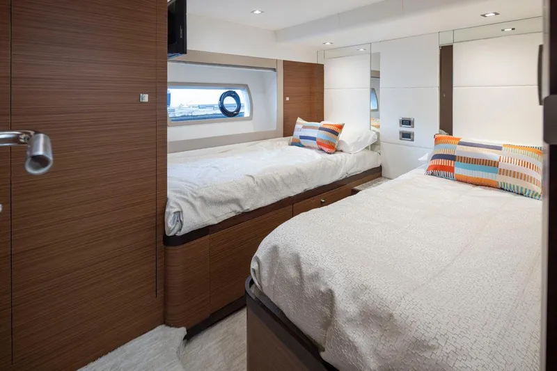 Crescent Moon Yacht Photos Pics Luxurious cabin interior of 2017 Ocean Alexander 70e yacht with twin beds and colorful pillows.