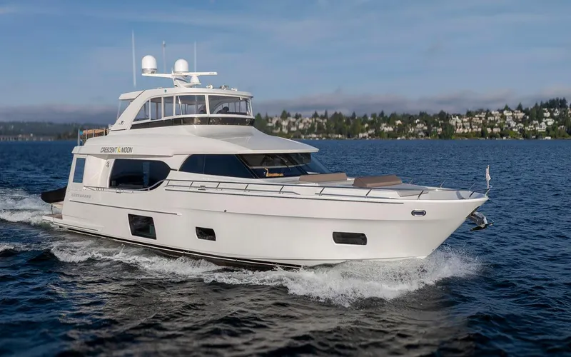 Crescent Moon Yacht Photos Pics 2017 Ocean Alexander 70E Motoryacht cruising on a serene lake with scenic background.