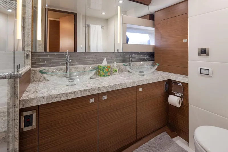 Crescent Moon Yacht Photos Pics Luxurious bathroom in 2017 Ocean Alexander 70E Motoryacht with dual glass sinks and modern fixtures.