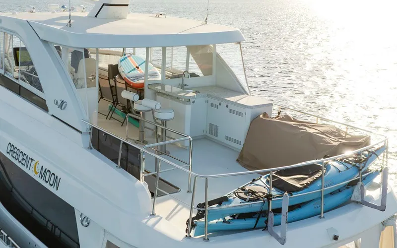 Crescent Moon Yacht Photos Pics 2017 Ocean Alexander 70E Motoryacht on water, featuring spacious deck and seating area.