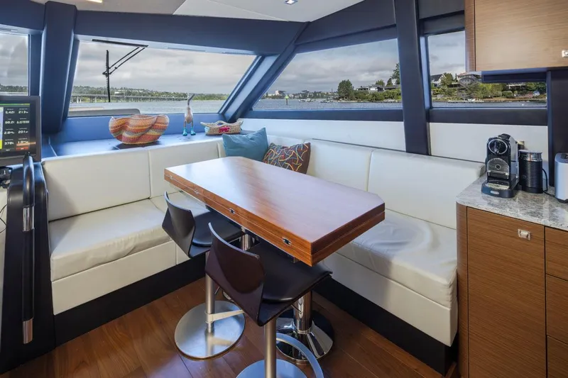 Crescent Moon Yacht Photos Pics Luxurious interior of 2017 Ocean Alexander 70E Motoryacht with dining area and scenic window view.