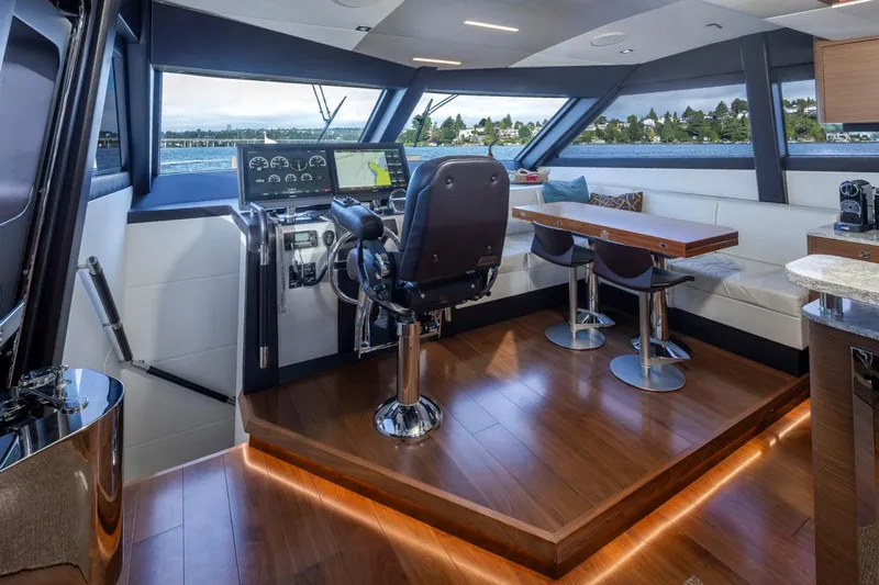 Crescent Moon Yacht Photos Pics Luxurious interior of 2017 Ocean Alexander 70E Motoryacht with helm and seating area.