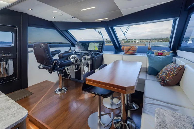 Crescent Moon Yacht Photos Pics Luxurious interior of 2017 Ocean Alexander 70E Motoryacht with helm and seating area.