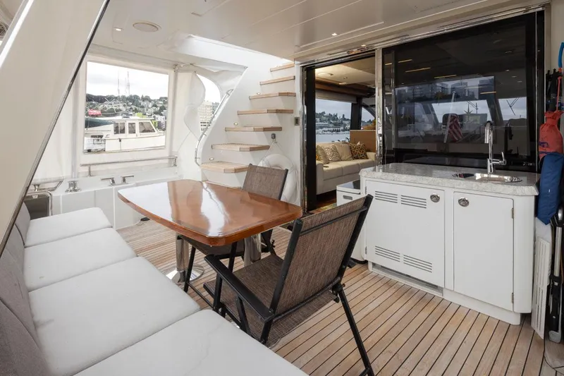 Crescent Moon Yacht Photos Pics Luxurious 2017 Ocean Alexander 70E Motoryacht interior with seating, table, and kitchenette.