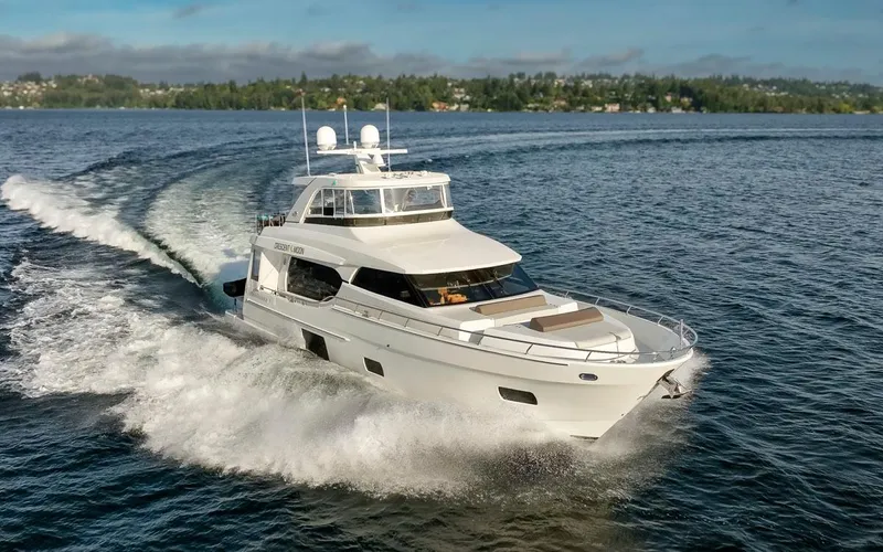 Crescent Moon Yacht Photos Pics 2017 Ocean Alexander 70E Motoryacht cruising on a serene lake under a clear sky.