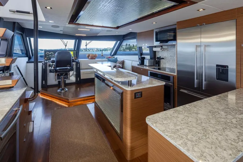 Crescent Moon Yacht Photos Pics Luxurious interior of 2017 Ocean Alexander 70E Motoryacht with modern kitchen and helm station.