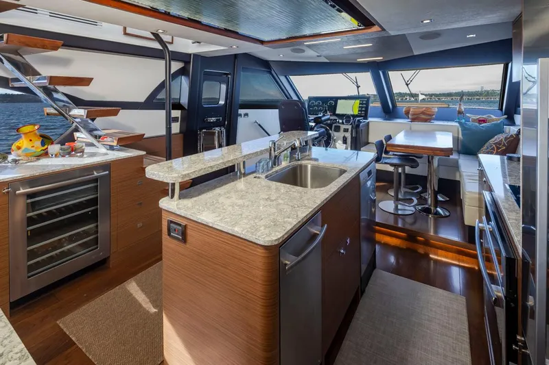 Crescent Moon Yacht Photos Pics Luxurious interior of 2017 Ocean Alexander 70E Motoryacht with modern kitchen and seating area.