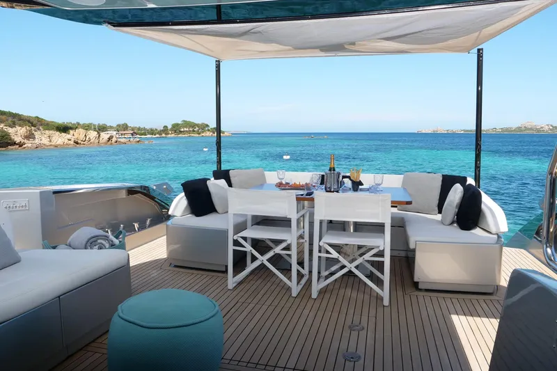  Yacht Photos Pics Luxurious 2017 Riva 76 Perseo yacht deck with elegant dining setup and stunning ocean view.