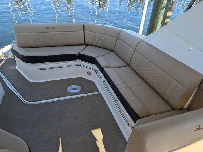  Yacht Photos Pics 2019 Sea Ray Sundancer 320 boat interior with beige seating and water view.