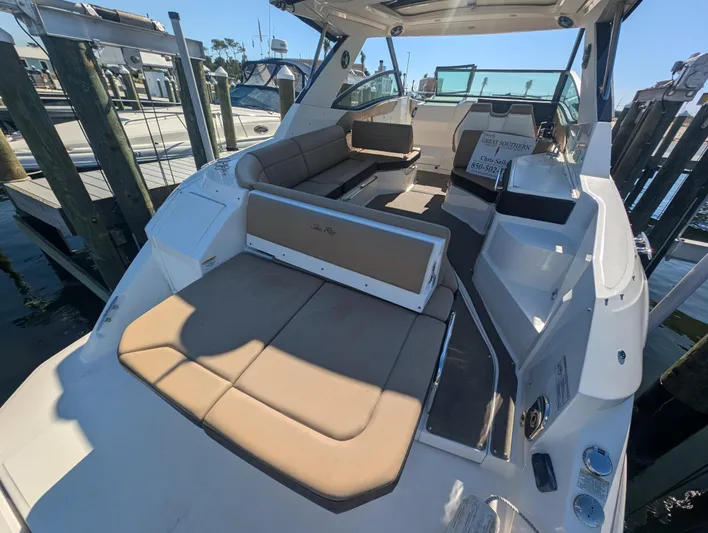  Yacht Photos Pics 2019 Sea Ray Sundancer 320 boat with spacious seating and modern design at a marina.