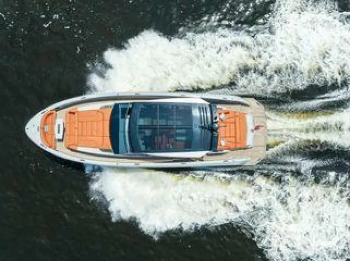 Incentivized Yacht Photos Pics Aerial view of 2021 Vanquish VQ58 yacht cruising on water, creating a dynamic wake.