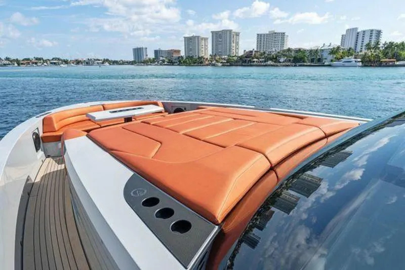 Incentivized Yacht Photos Pics Vanquish VQ58 yacht with orange sunbathing deck, city skyline in background, 2021 model.