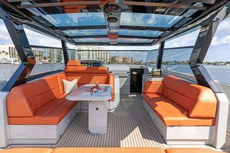 Incentivized Yacht Photos Pics Luxurious 2021 Vanquish VQ58 yacht interior with orange seating and panoramic views.