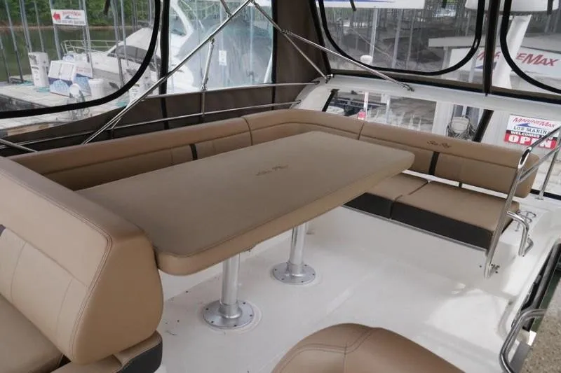 Necessity Yacht Photos Pics Luxurious interior of 2017 Sea Ray Fly 400 yacht with beige seating and table.