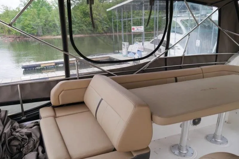 Necessity Yacht Photos Pics 2017 Sea Ray Fly 400 interior with beige seating, dock view, and large windows.