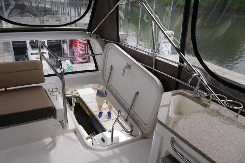 Necessity Yacht Photos Pics 2017 Sea Ray Fly 400 interior with open hatch and seating area.