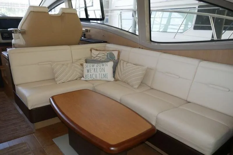 Necessity Yacht Photos Pics 2017 Sea Ray Fly 400 yacht interior with cream leather seating and wooden table.