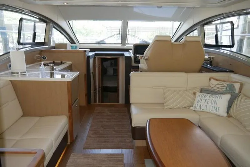 Necessity Yacht Photos Pics Luxurious interior of 2017 Sea Ray Fly 400 yacht with modern seating and kitchen area.