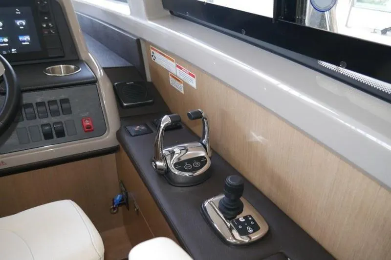 Necessity Yacht Photos Pics Control panel of 2017 Sea Ray Fly 400 yacht with throttle and joystick.