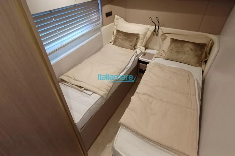  Yacht Photos Pics Luxurious twin cabin interior of 2025 Azimut Fly 60 yacht with beige bedding.