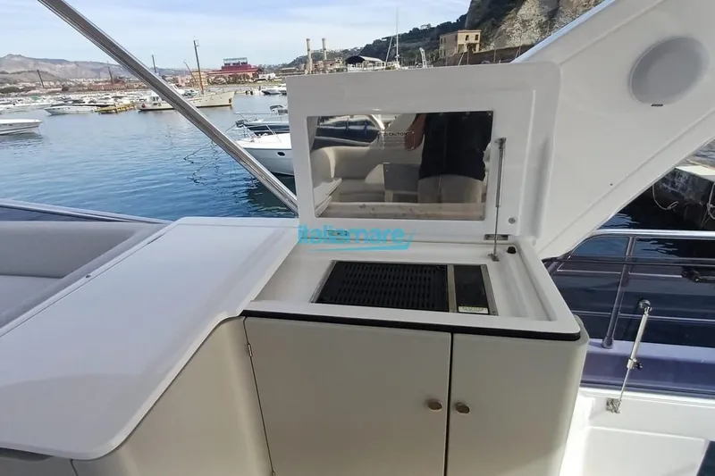  Yacht Photos Pics Outdoor kitchen on 2025 Azimut Fly 60 yacht, overlooking marina.