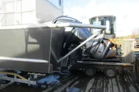 Damaged 2023 Robust LC1227 boat on trailer, showing significant structural impact.