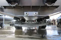 Underneath view of a 2023 Robust LC1227 boat trailer on a wet surface.
