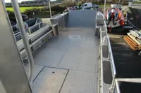 Open deck of a 2023 Robust LC1227 boat, featuring aluminum flooring and railing.