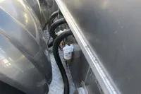 Engine compartment of a 2023 Robust LC1227 with visible hoses and components.