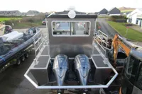 Robust LC1227 boat with dual 225 V6 engines, parked near residential area, 2023 model.