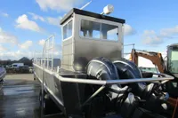 Aluminum boat with dual outboard motors, Robust LC1227 model, 2023, docked under blue sky.